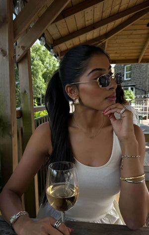 The Rest Of The World Can Wait East-West Silver Ring showcased on a woman wearing stylish sunglasses and elegant jewelry.