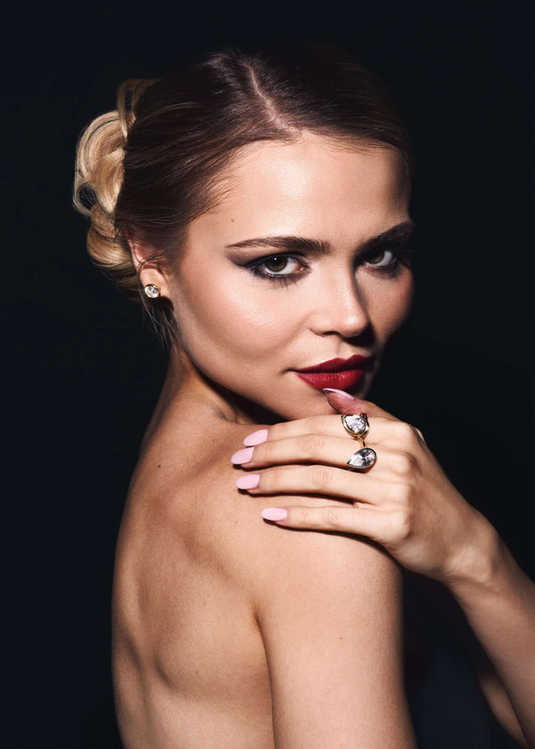 The Perfect Amount Of Too Much Gold Stud Earring worn by a woman with elegant makeup and hairstyle.