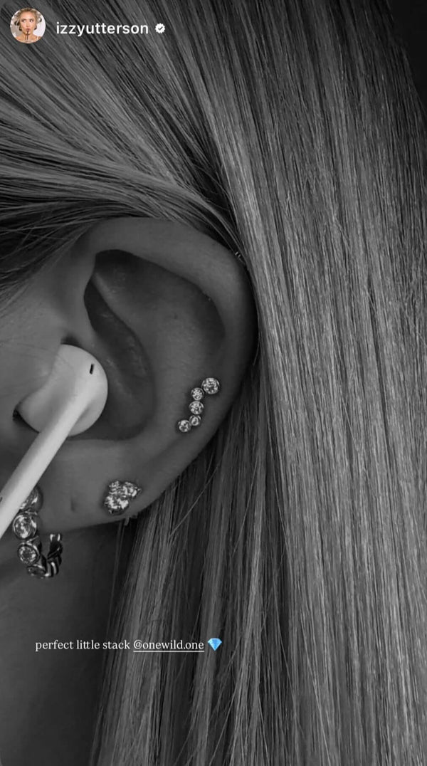 Close-up of an ear showcasing Holy Chic! Earrings from OneWildOne with sparkle and elegance.