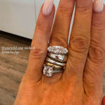 The Rest Of The World Can Wait East-West Silver Ring on a hand with long nails and a warm background.