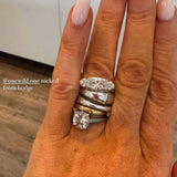 The Rest Of The World Can Wait East-West Silver Ring on a hand with long nails and a warm background.