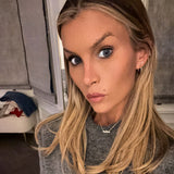 This Wild Soul Script Necklace worn by a model with long blonde hair and a cozy grey sweater.