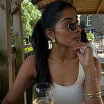 The Rest Of The World Can Wait East-West Silver Ring showcased on a woman wearing stylish sunglasses and elegant jewelry.