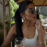 The Rest Of The World Can Wait East-West Silver Ring showcased on a woman wearing stylish sunglasses and elegant jewelry.