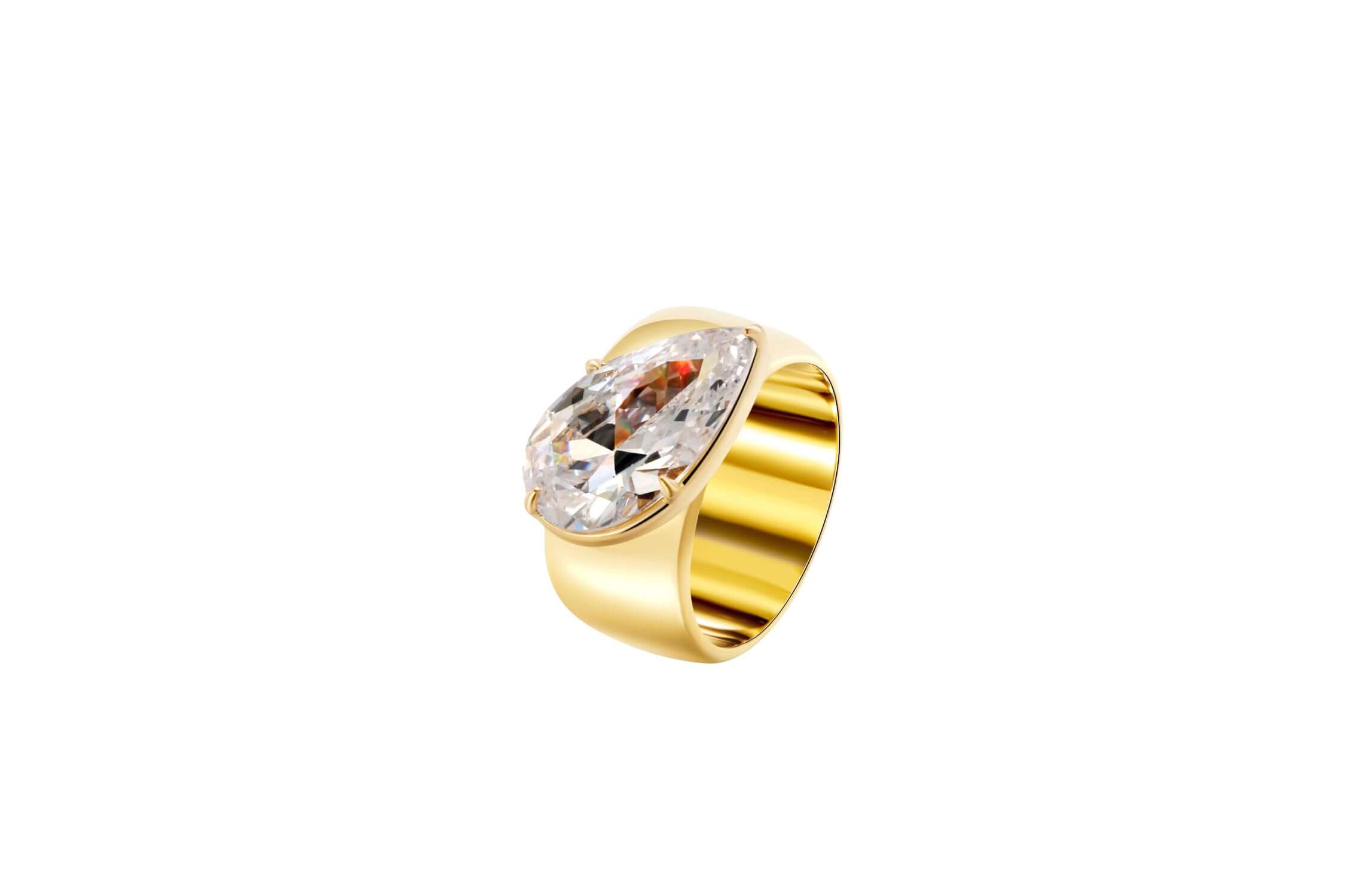 A Wonderful Thing Tilted Pear Cigar Band Ring featuring a large cubic zirconia set in a gold-plated brass band.