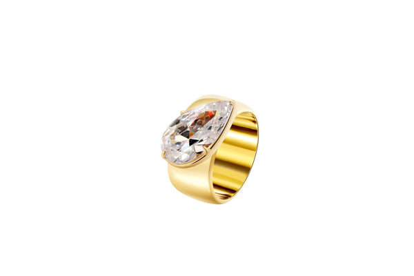 A Wonderful Thing Tilted Pear Cigar Band Ring featuring a large cubic zirconia set in a gold-plated brass band.