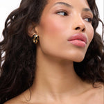 Model showcasing Born To Be Wild Leopard Earrings with a high-gloss leopard print design.