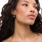 Model showcasing Born To Be Wild Leopard Earrings with a high-gloss leopard print design.