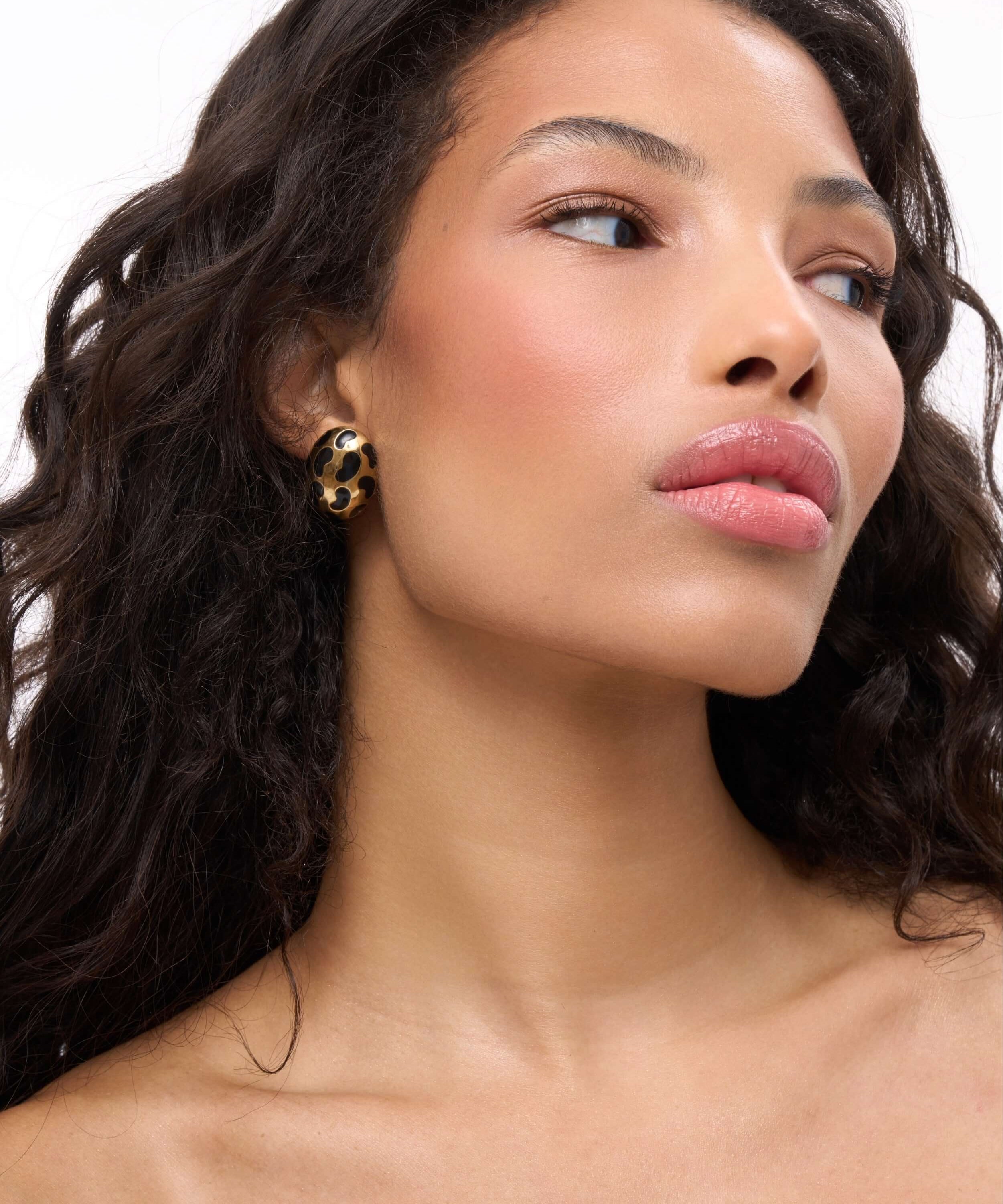 Model showcasing Born To Be Wild Leopard Earrings with a high-gloss leopard print design.