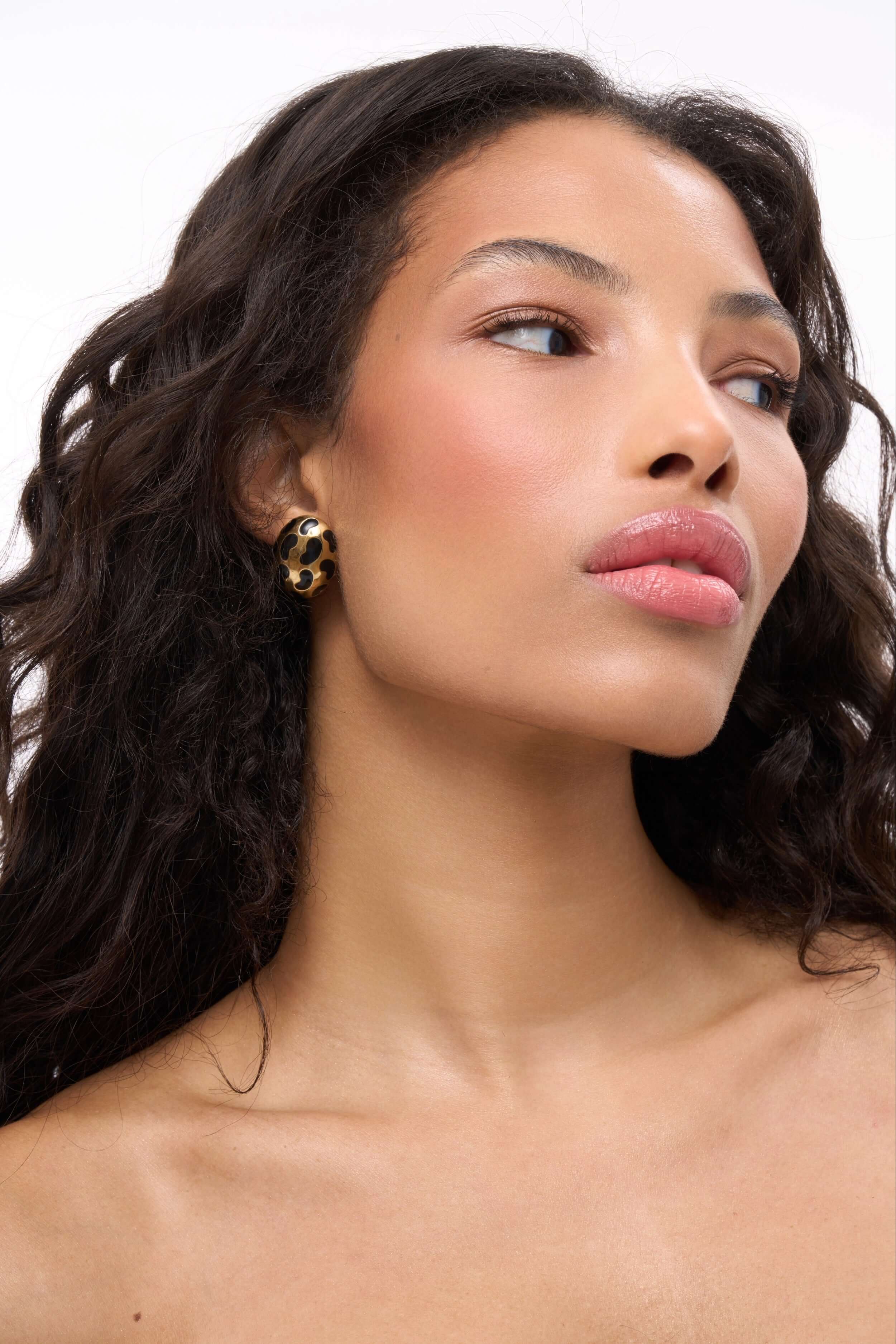 Model showcasing Born To Be Wild Leopard Earrings with a high-gloss leopard print design.