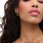 Born To Be Wild Leopard Earrings worn by a model with glowing skin, showcasing bold leopard print and statement jewelry.