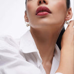Model wearing Good Times Earrings showcasing elegance and sparkle with a close-up of her face and jewelry.