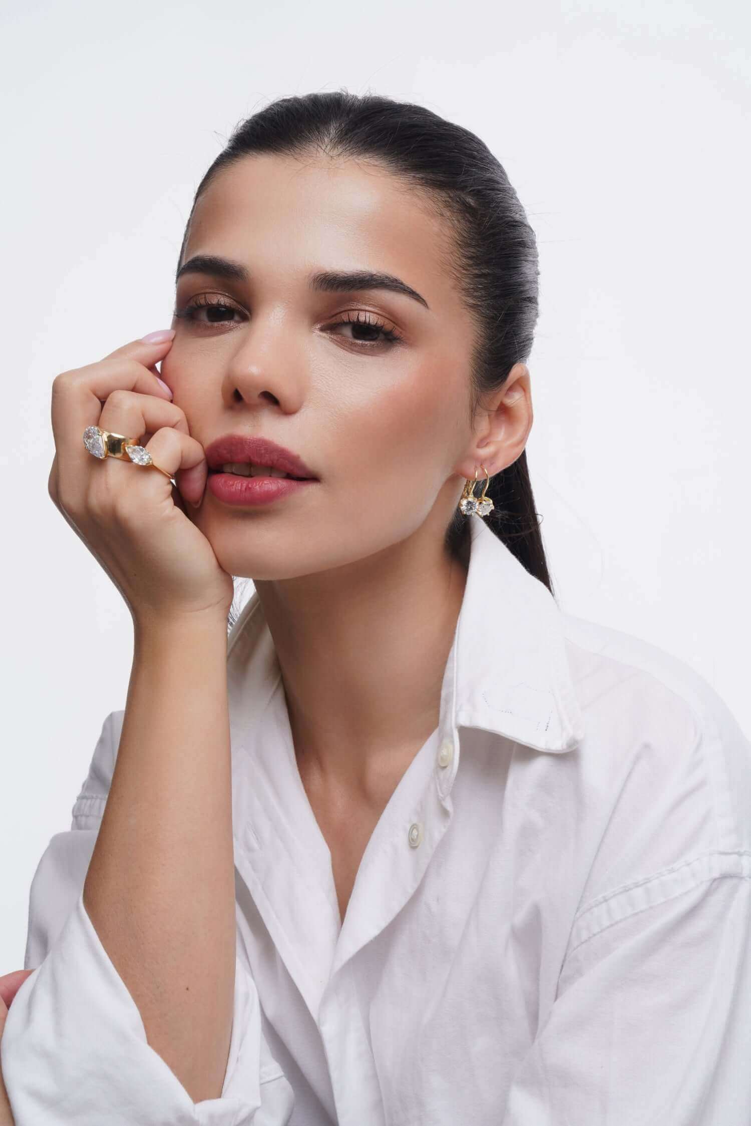 Model wearing Good Times Earrings and a stylish shirt, showcasing elegance and sparkle with cubic zirconia.