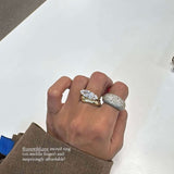 A hand wearing two stylish rings on fingers, showcasing the East-West Silver Ring design.