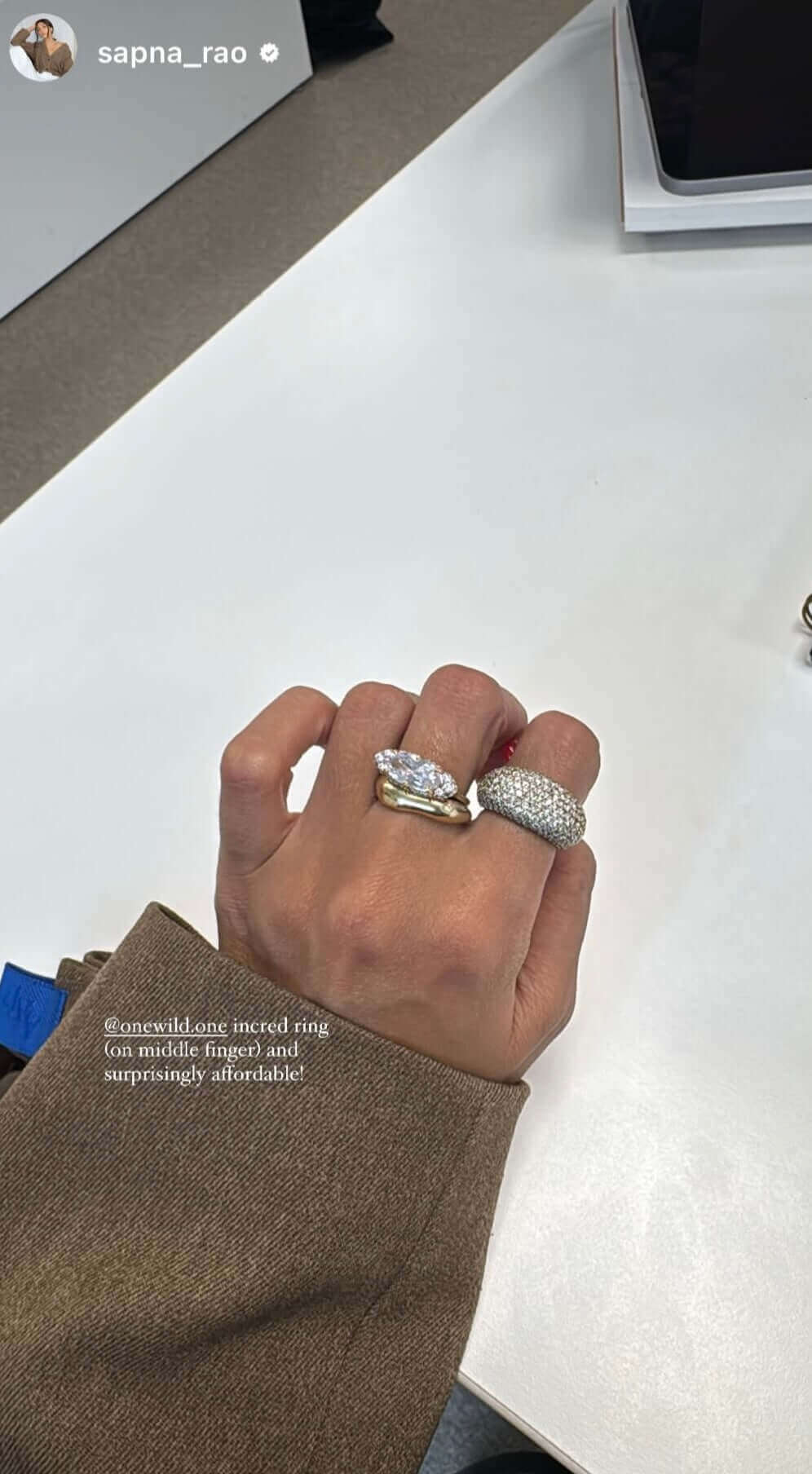 A hand wearing two stylish rings on fingers, showcasing the East-West Silver Ring design.