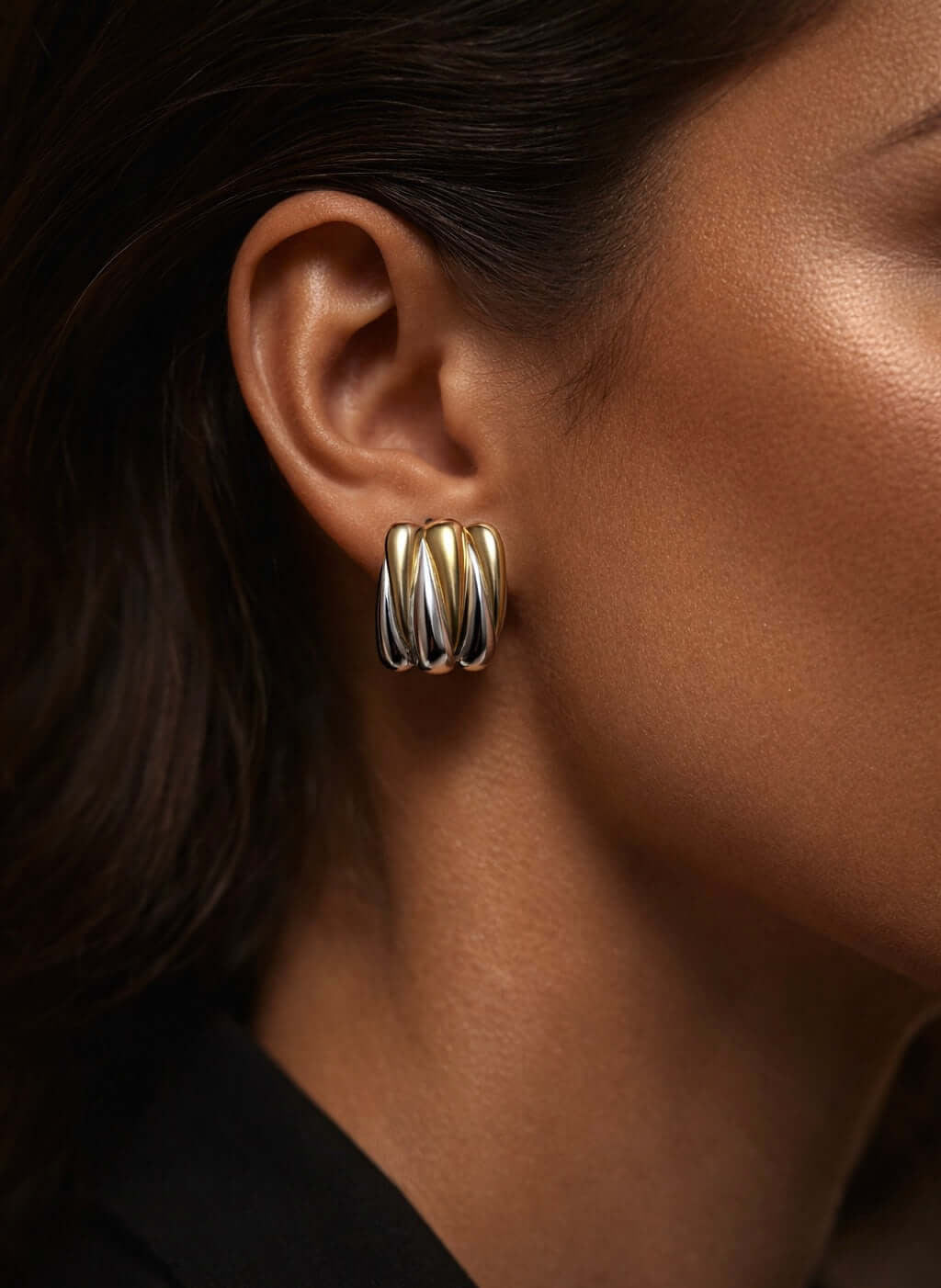 Close-up of a model wearing Wild Thing Two-Tone Zig-Zag Earrings showcasing the gold and silver design.
