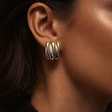 Close-up of a model wearing Wild Thing Two-Tone Zig-Zag Earrings showcasing the gold and silver design.