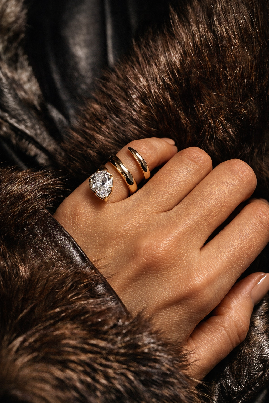 When You Know You Know Gold Twisted Snake Pinky Ring on a hand with gold bands and a sparkling stone, showcasing elegant jewelry fashion.