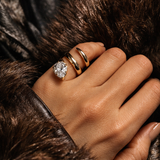 When You Know You Know Gold Twisted Snake Pinky Ring on a hand with gold bands and a sparkling stone, showcasing elegant jewelry fashion.