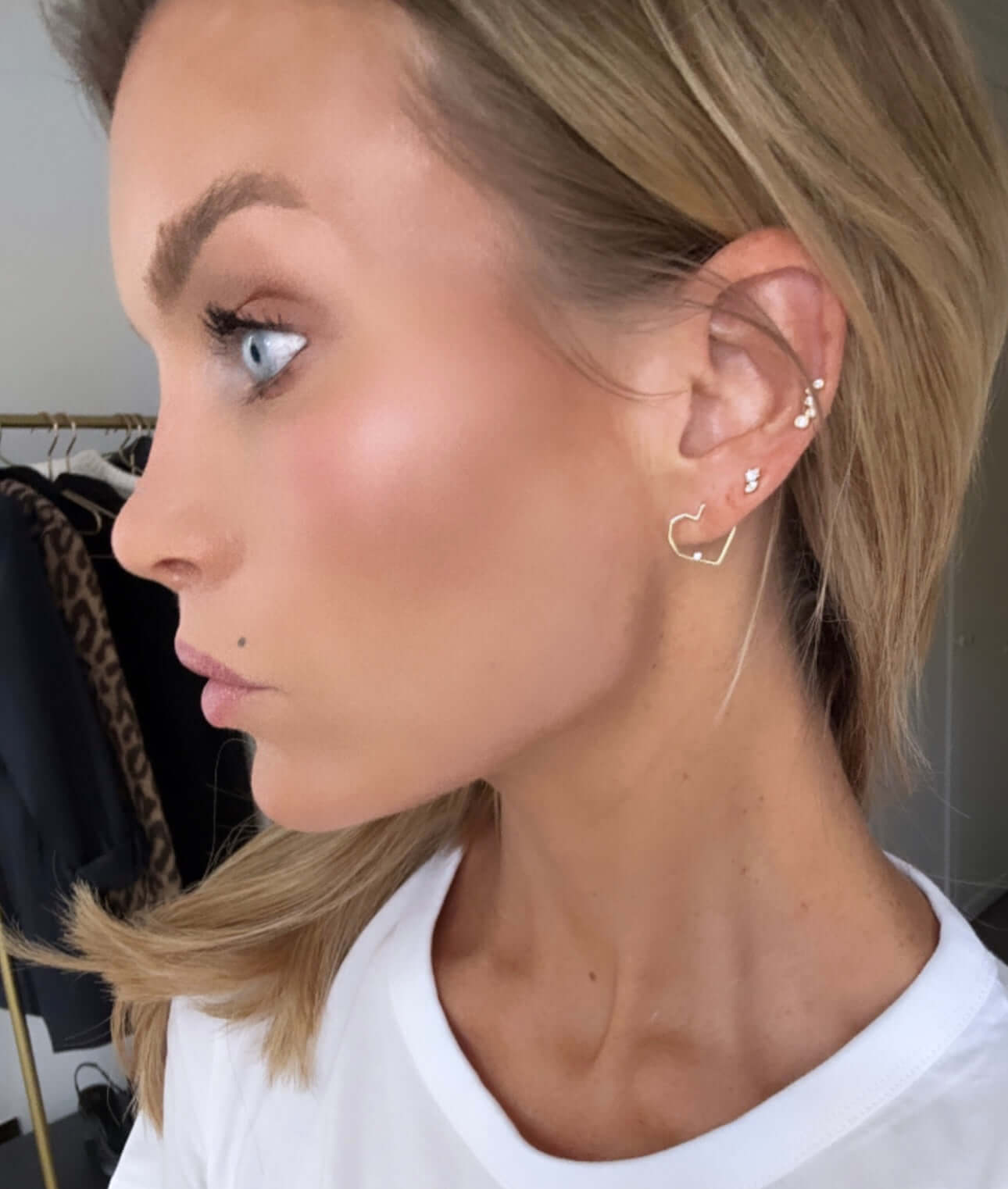 Model showcasing Follow Your Heart Gold Earrings, displaying elegant design and sophisticated style.