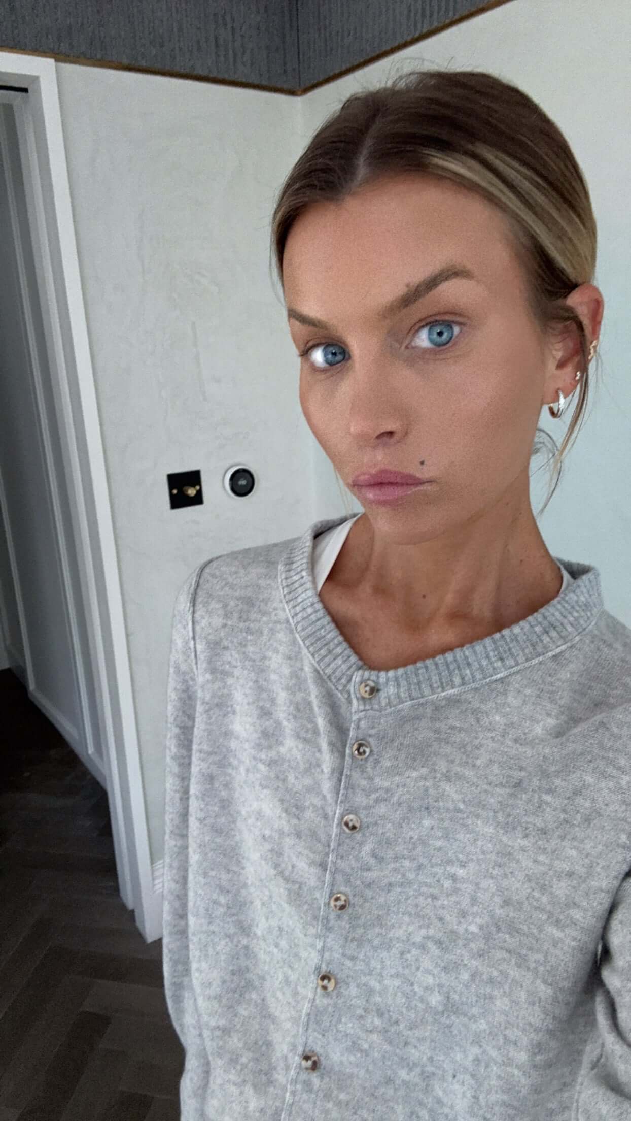 You Are Perfect Gold Hoop Earrings worn by a model with a grey sweater and natural makeup, showcasing elegance and style.
