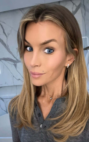 Woman with long hair wearing a grey top, showcasing the You Are Amazing And I Love You Heart Necklace.