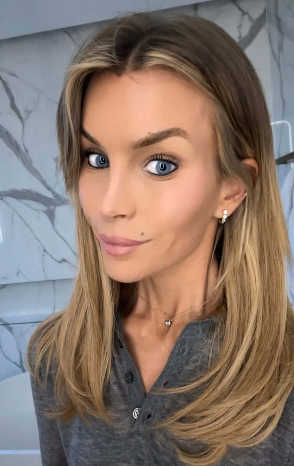 Woman with long hair wearing a grey top, showcasing the You Are Amazing And I Love You Heart Necklace.