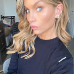 Close-up of a model wearing the More Of What Makes You Happy Earring Single Unit with styled hair and natural makeup.