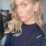 Close-up of a model wearing the More Of What Makes You Happy Earring Single Unit with styled hair and natural makeup.