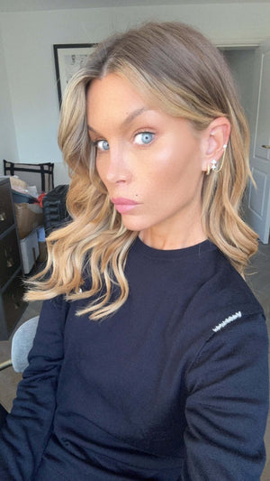 Close-up of a model wearing the More Of What Makes You Happy Earring Single Unit with styled hair and natural makeup.
