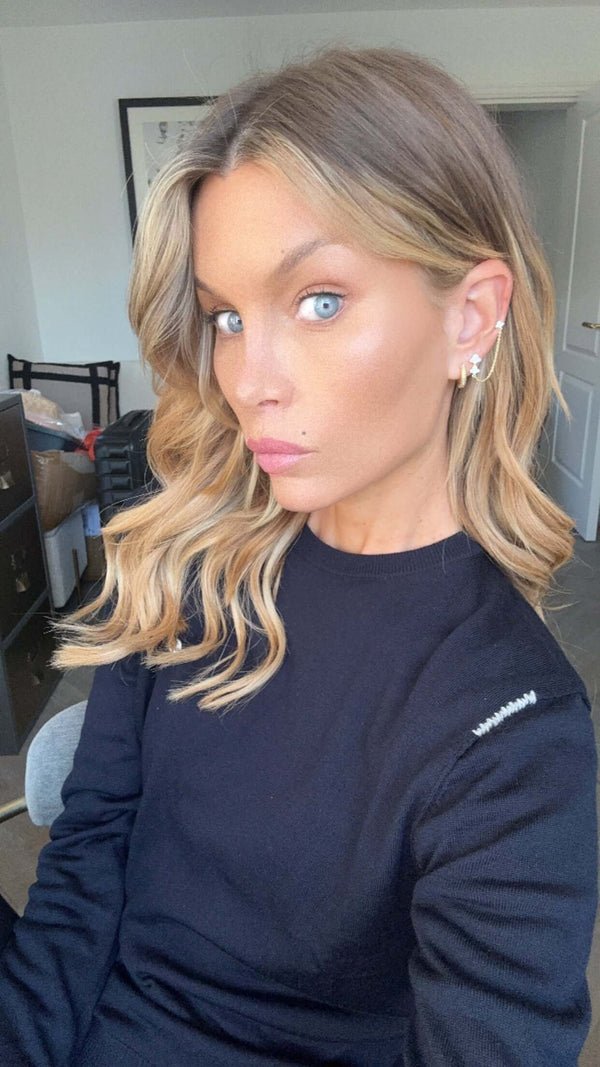 Close-up of a model wearing the More Of What Makes You Happy Earring Single Unit with styled hair and natural makeup.