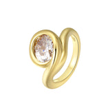 Bonjour Mon Amour Ring featuring an oversized round-cut stone in a smooth sculptural design with gold PVD plating.