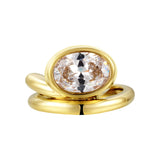 Love You Back Ring featuring an oversized oval-cut stone in a fluid sculptural setting with gold plating.