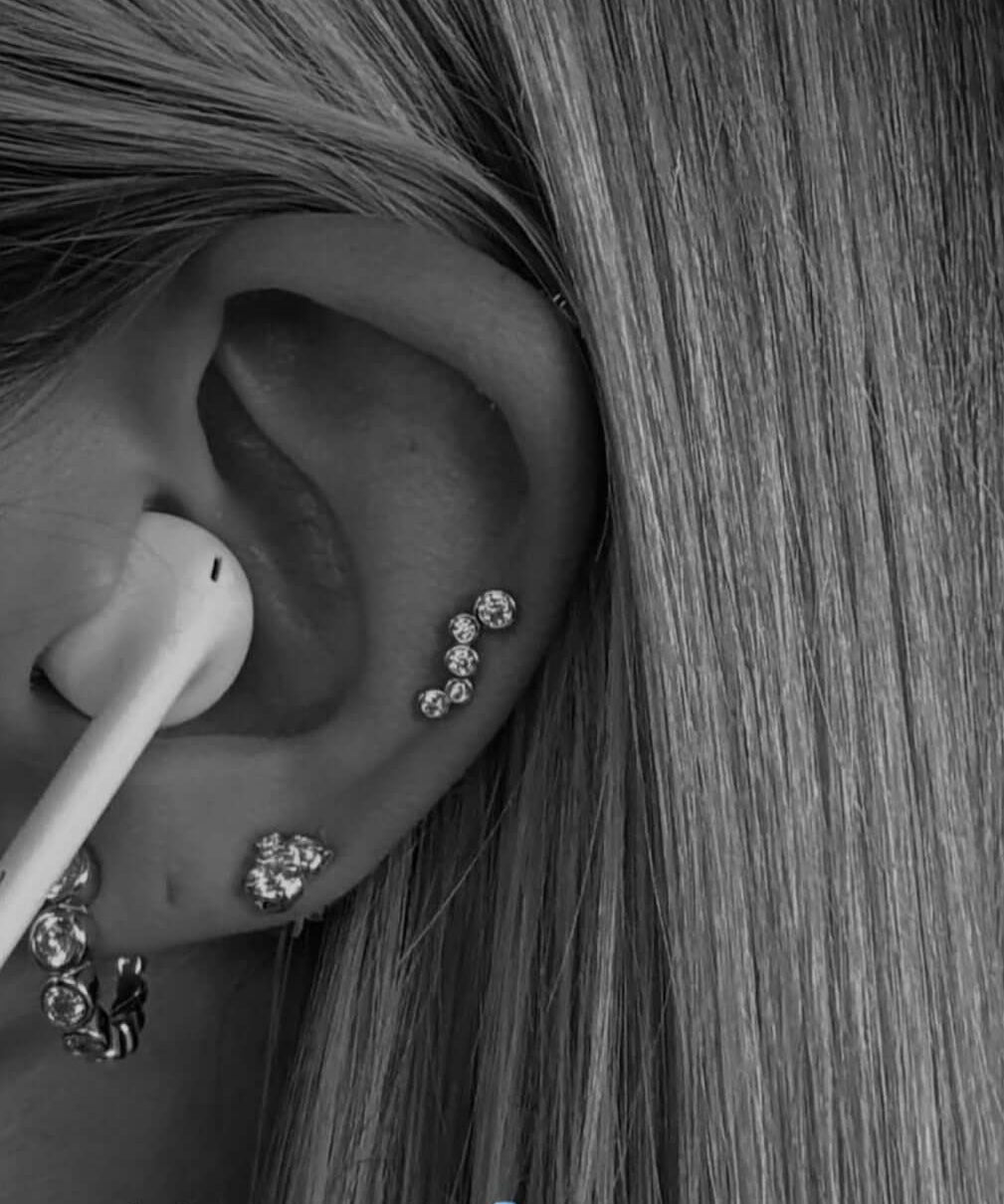 Close-up of an ear showcasing Holy Chic! Earrings from OneWildOne with sparkle and elegance.