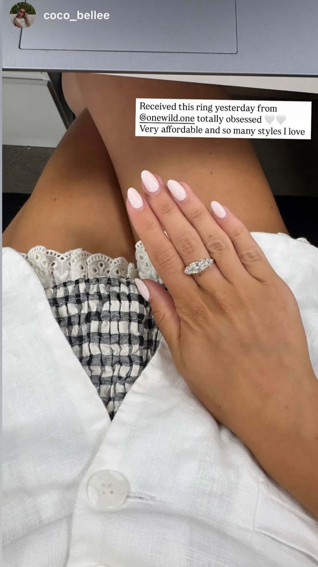 The Rest Of The World Can Wait East-West Silver Ring worn on a hand with manicured nails.