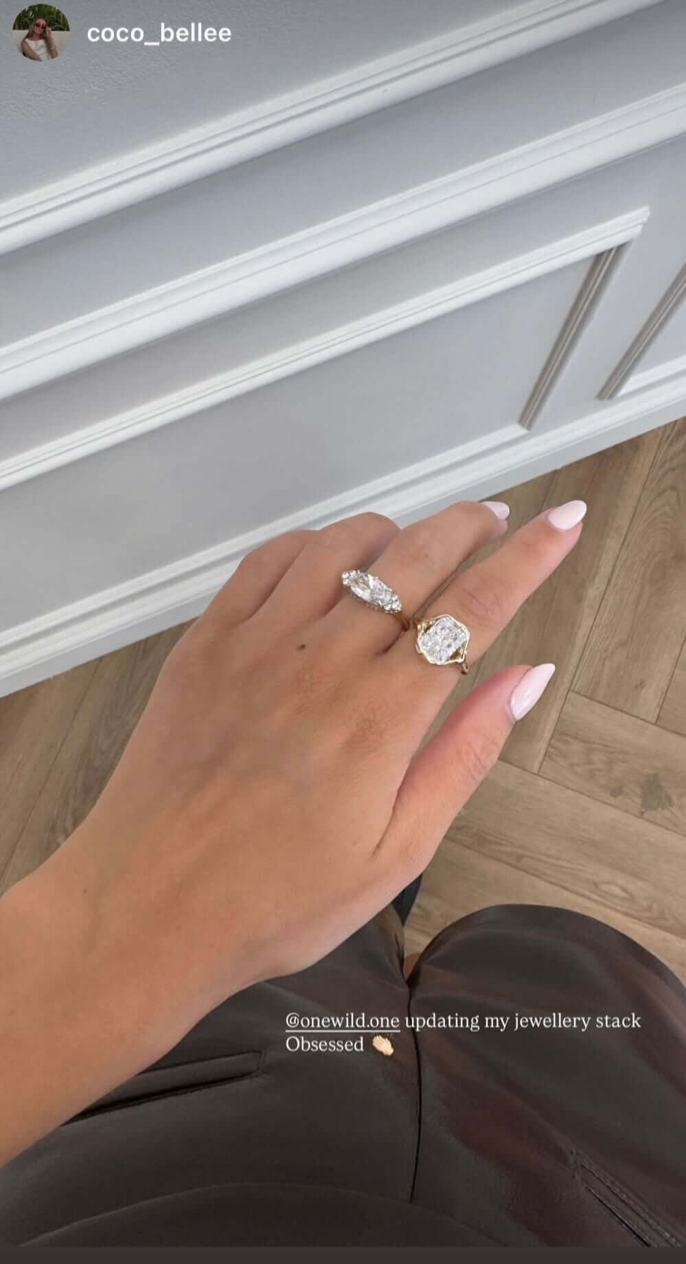 Close-up of a hand wearing rings, showcasing the Be Your Own Muse Gold Ring among other jewelry pieces.
