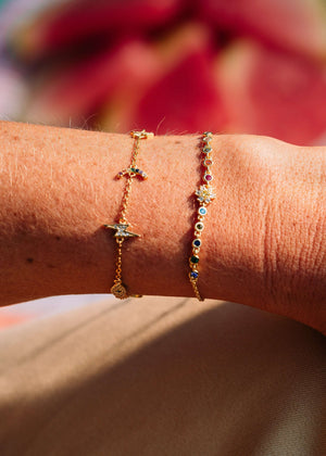Sunshine + Rainbows Flower Chain Bracelet worn on wrist with colorful stones and gold detailing.