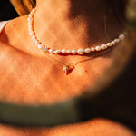 Pearl's A Singer Necklace featuring freshwater pearls on a silver chain with 14k gold plating and cubic zirconia.