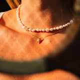 Pearl's A Singer Necklace featuring freshwater pearls on a silver chain with 14k gold plating and cubic zirconia.