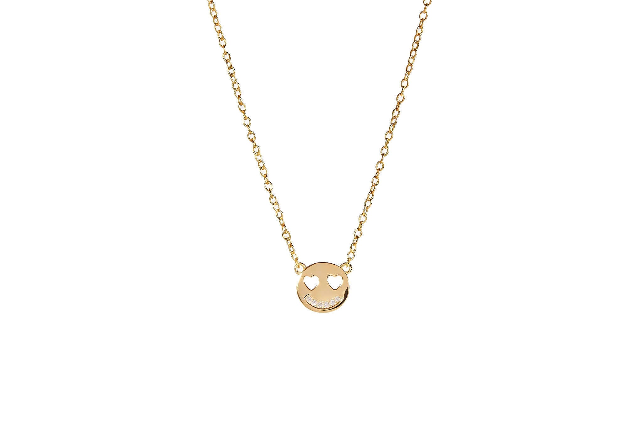 Wild Smile Emoji Necklace featuring a gold plated smiling emoji pendant with heart eyes on a delicate chain.