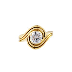 Love You More Solitaire Ring featuring a brilliant round stone wrapped in fluid gold curves.