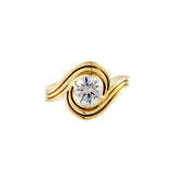 Love You More Solitaire Ring featuring a brilliant round stone wrapped in fluid gold curves.