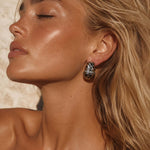 Model wearing Just Do You Leopard Silver Earrings with radiant skin and tousled hair, showcasing a stylish and elegant look.