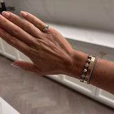 Soft Life Gold East West Pinky Ring worn on hand with stylish bracelets in elegant setting.