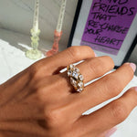 Hand wearing the It Girl Ring, showcasing its chunky gold band and precision-cut stones.