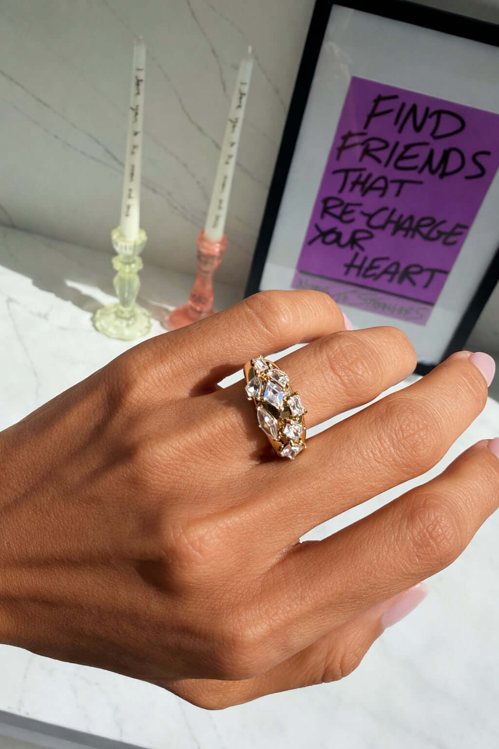 Hand wearing the It Girl Ring, showcasing its chunky gold band and precision-cut stones.