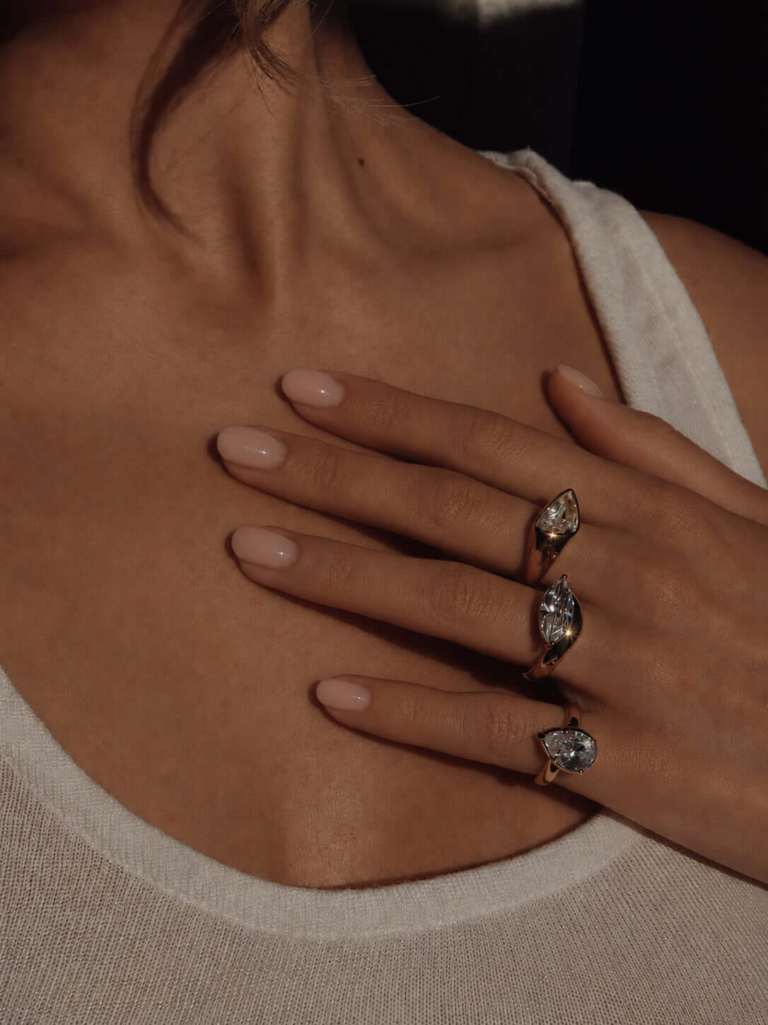 Excited About Everything Pinky Ring worn among other rings, showcasing its oversized pear-cut design and two-tone finish.