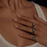 Excited About Everything Pinky Ring worn among other rings, showcasing its oversized pear-cut design and two-tone finish.